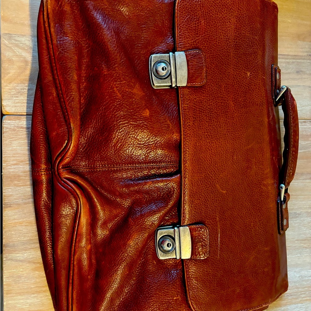 Wilson's Brown leather briefcase. Interior does have some wear and tear.